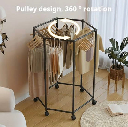 Clothing rack with pulley system for 360-degree rotation in a room setting.