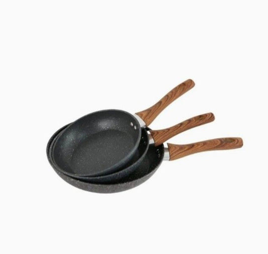 Three black frying pans with wooden handles on a white background