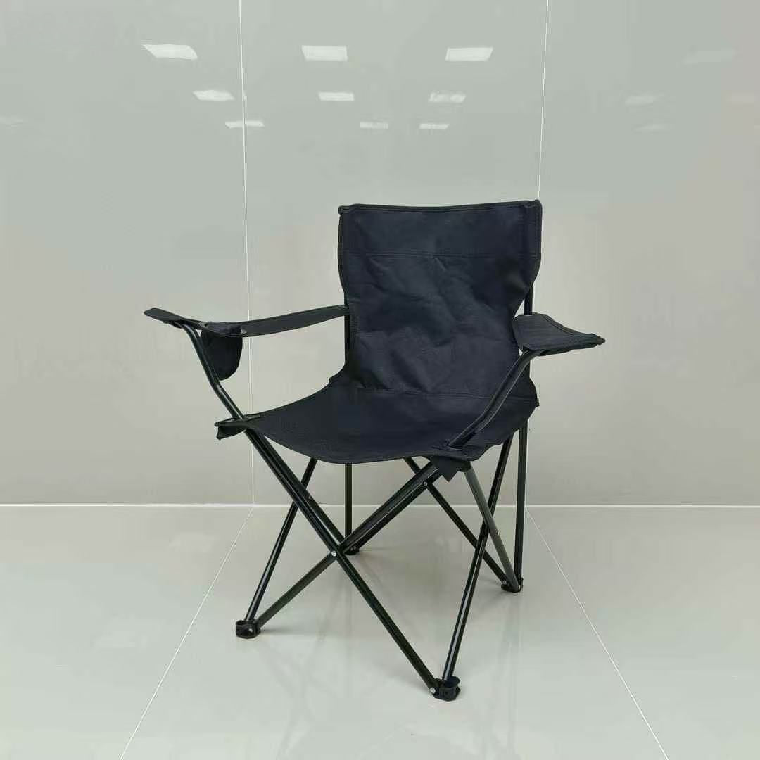 Black folding chair on a white floor with a light gray wall background