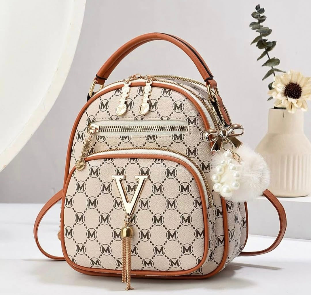 Designer handbag with brand logo on a neutral background