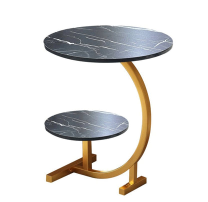 Round side table with marble top and gold curved base on a white background
