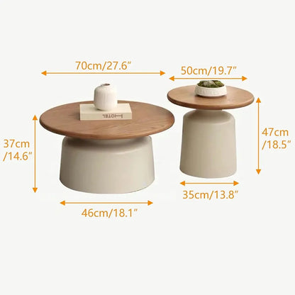 Two modern low coffee tables with cylindrical off-white bases and round medium-brown wooden tops, shown with dimension arrows and labels indicating width, height, and depth on a light gray background.