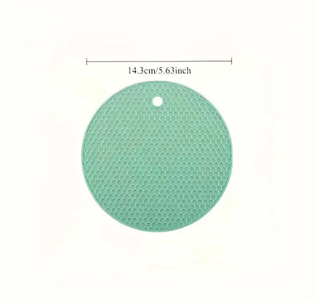 Green round silicone mat with measurement text on a white background