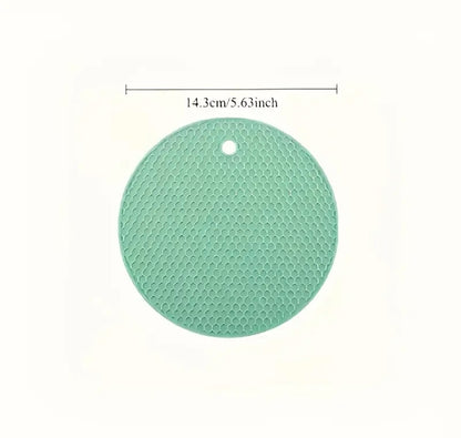 Green round silicone mat with measurement text on a white background