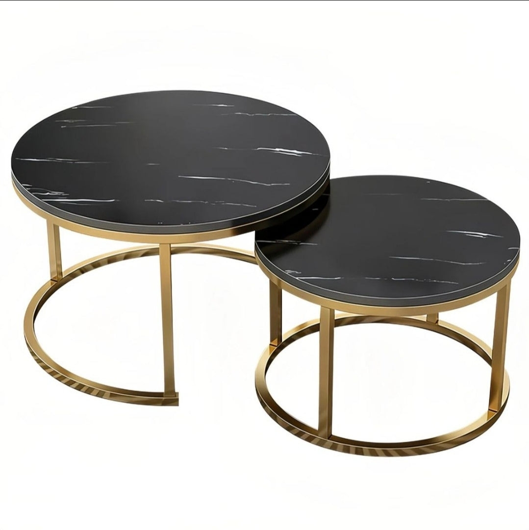 Two nesting round nesting tables with black marble-patterned tops and gold-finished metal bases, shown on a plain white background.