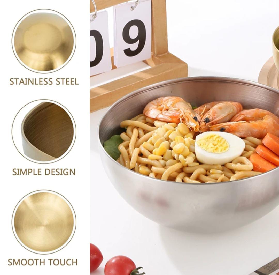 Stainless steel bowl with noodles, shrimp, and vegetables on a white background