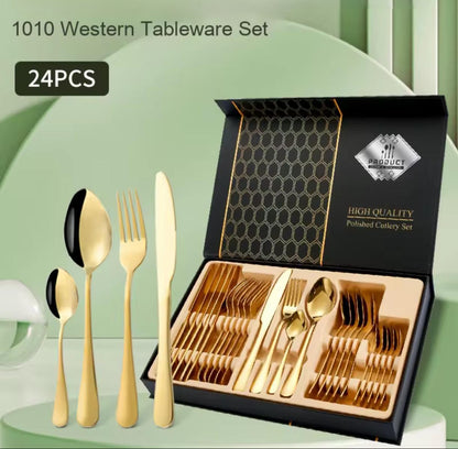 24-piece Western tableware set with gold cutlery in an open black box on a light green background.