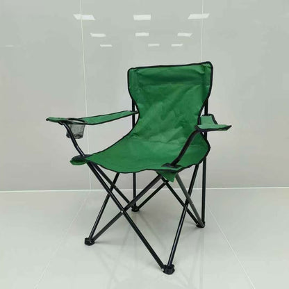Green folding chair on a white floor with a light gray wall background