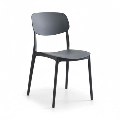A modern black molded plastic dining chair with a curved backrest and four tapered legs, shown from a three-quarter angle on a white studio background.
