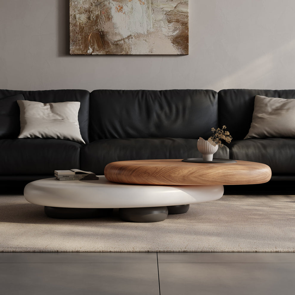 Modern living room with a black sofa, wooden coffee table, and abstract painting on the wall.
