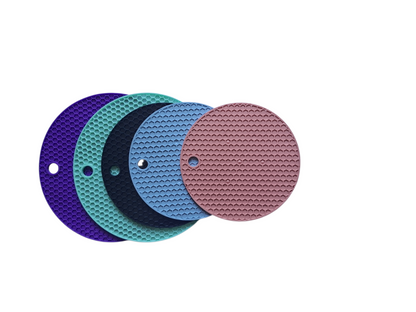Set of five circular sanding discs in purple, green, blue, and pink on a white background