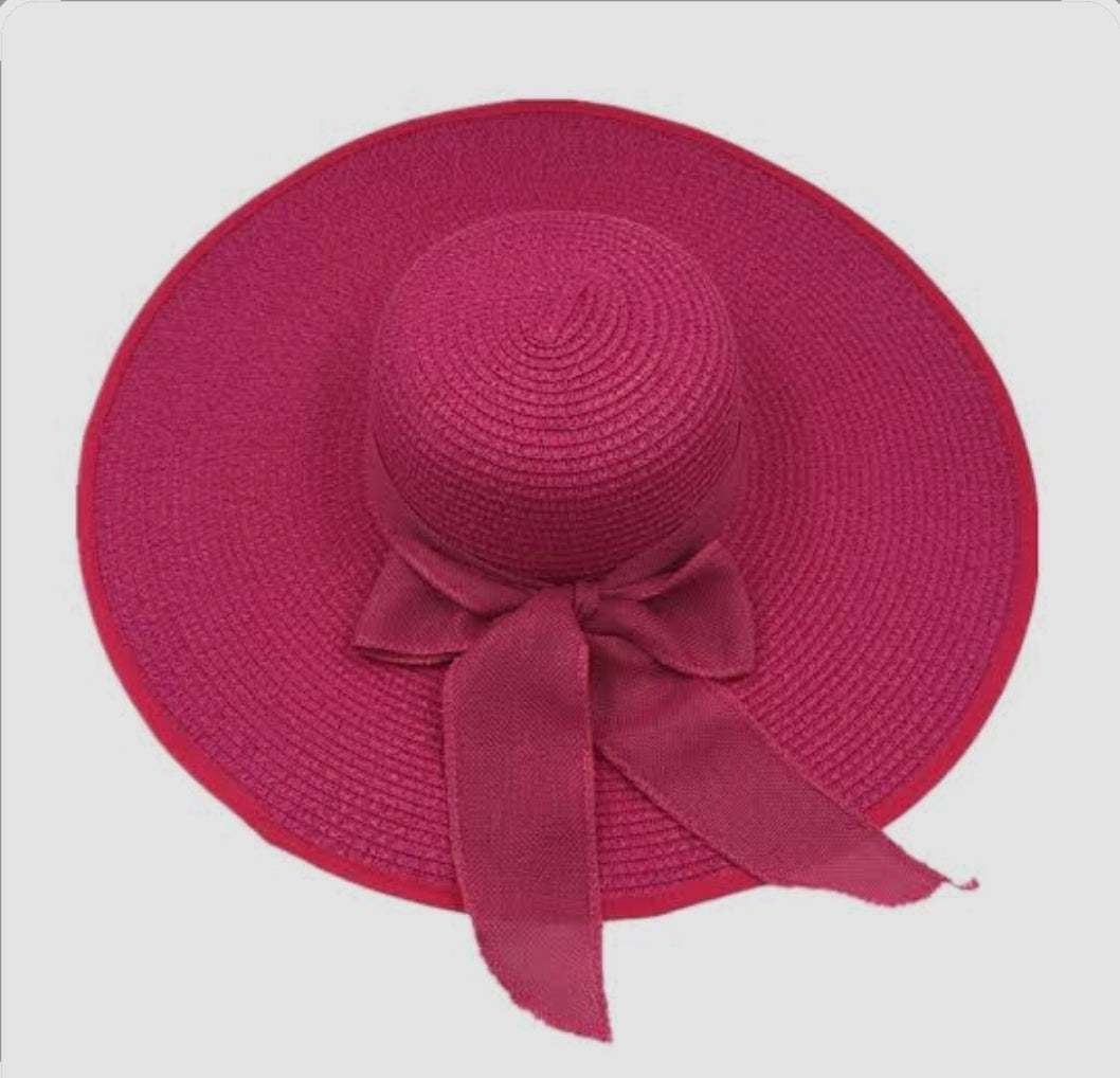 Red straw hat with a bow on a white background