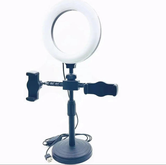 Ring light with stand and phone holder on a white background
