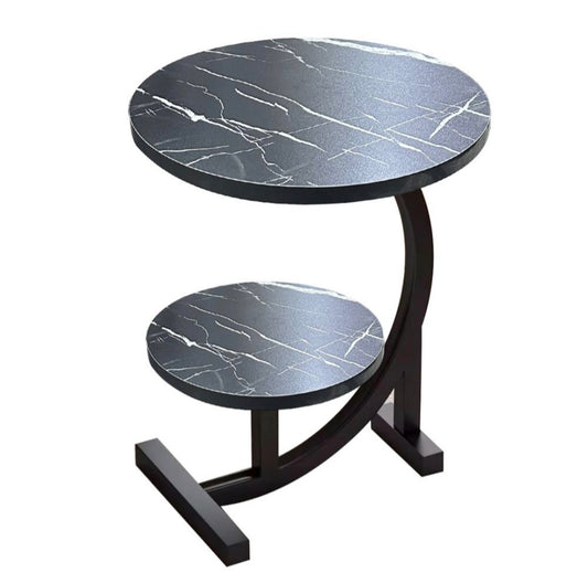 Round side table with marble-like top and black base on a white background