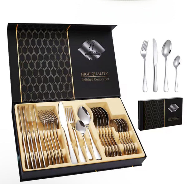 Set of silver cutlery in a black and gold box with 'High Quality' label.