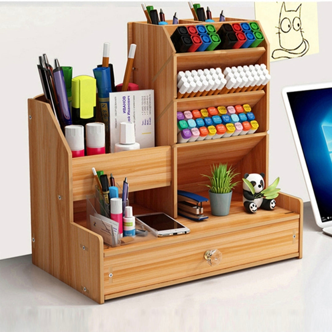 Wooden desk organizer with stationery items on a desk.