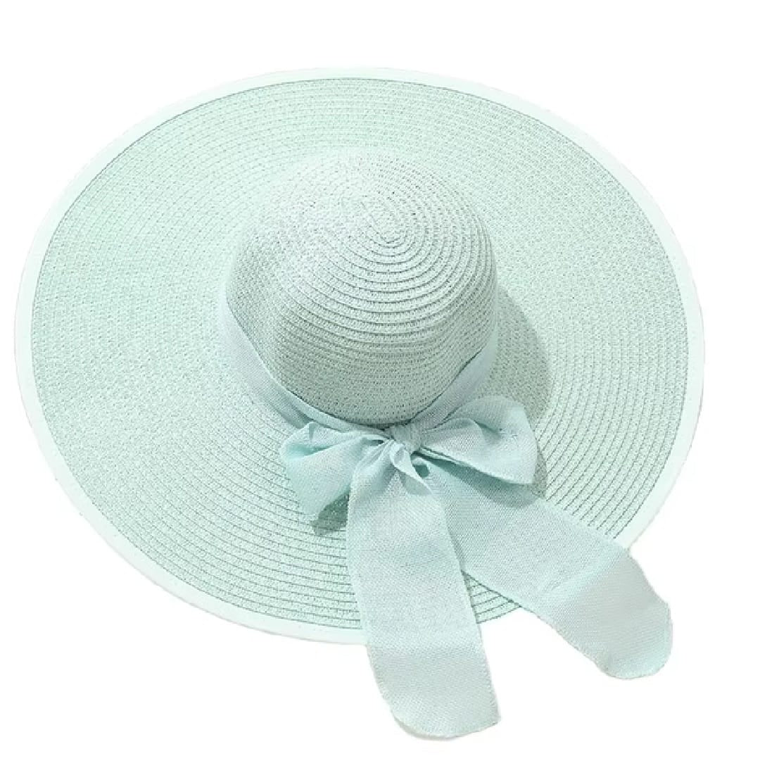 Teal straw hat with a ribbon on a white background