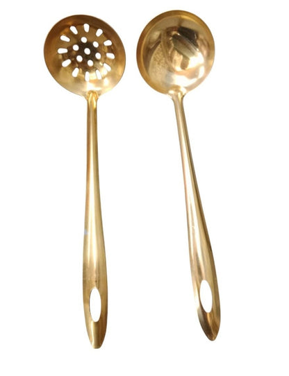 Two gold-colored kitchen utensils on a white background