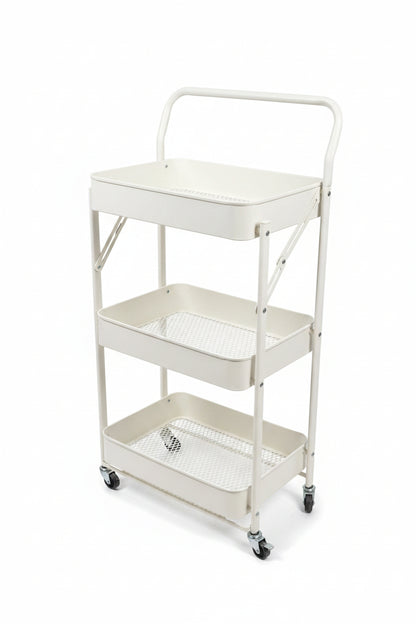 A three-tier white metal rolling cart with mesh shelves and a top handle, shown in an indoor showroom setting with gray tiled floors and storage cabinets in the background.