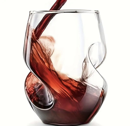 Red wine being poured into a unique glass design on a white background
