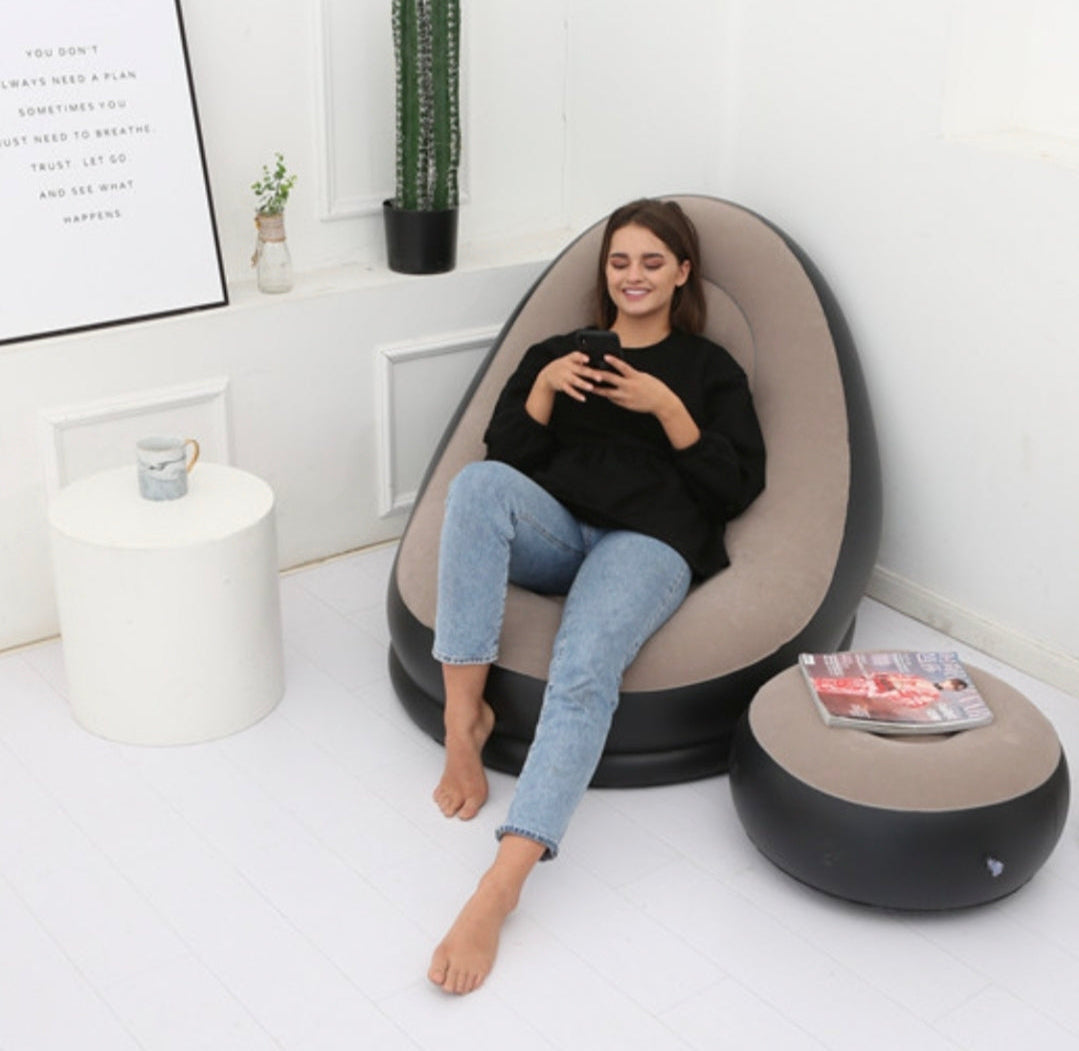 Woman sitting on a bean bag chair in a modern living room.