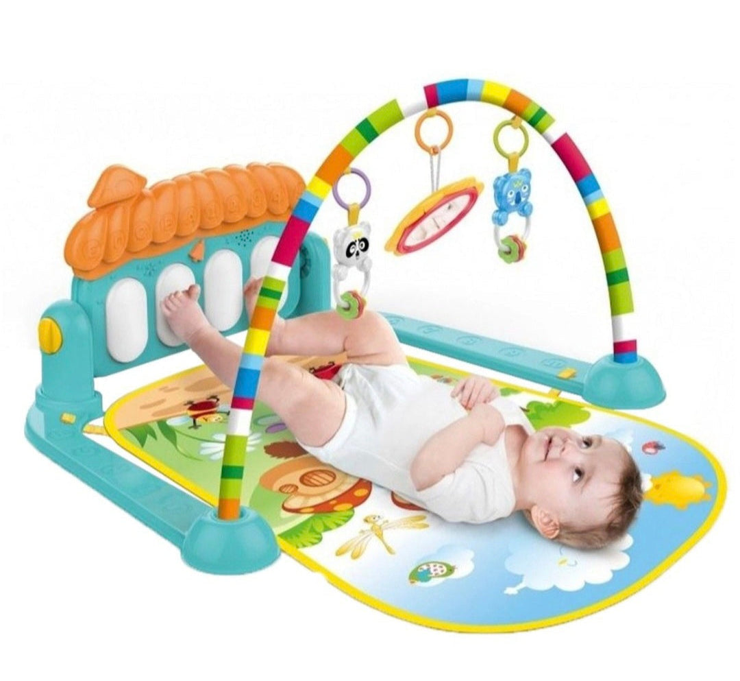 Baby playing on a colorful activity gym with toys hanging above