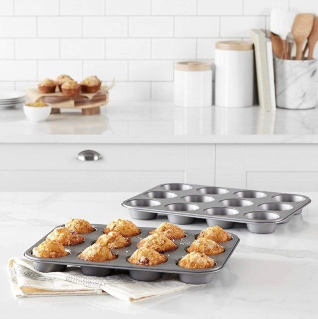 Baking trays with muffins on a kitchen counter